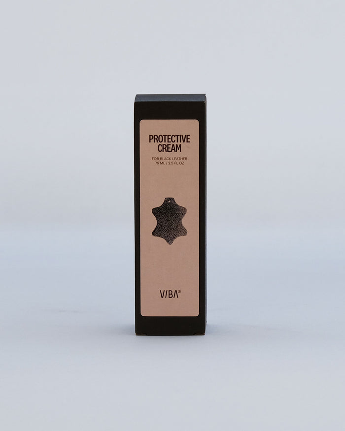 Black rectangular box with beige label reading "Protective Cream for Black Leather," 75ml, featuring a leather swatch icon an