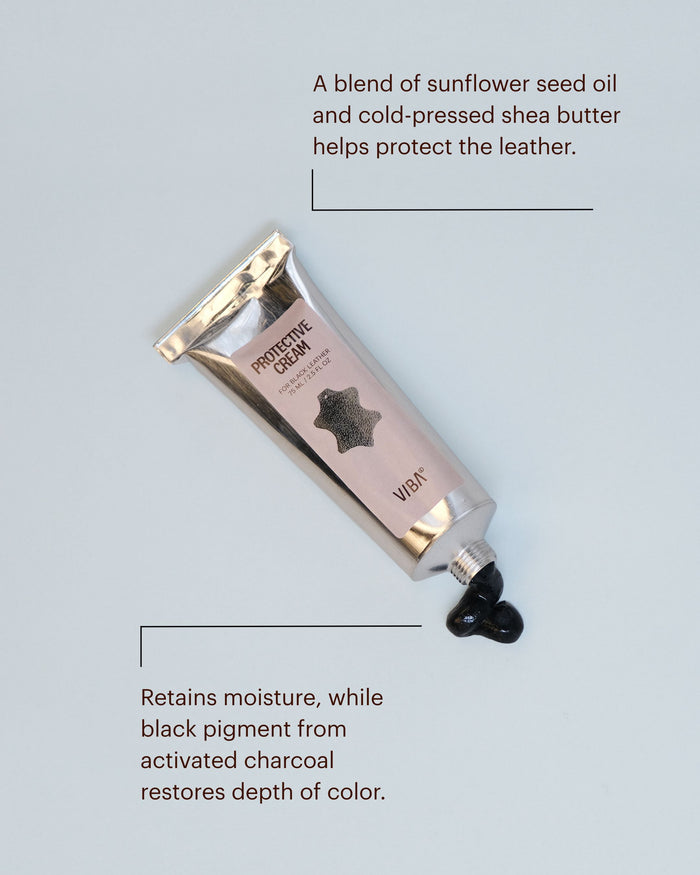 Tube of black protective cream with gold cap, displaying product label and black cream sample squeezed out below.