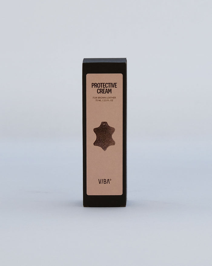 Brown leather protective cream in a tall black box, 75 ml, with leather texture icon on beige label.