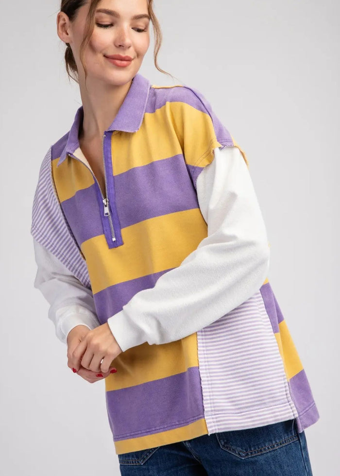 oversized collared rugby style pullover, with yellow and light purple block stripes, white sleeves and 1/4 zip