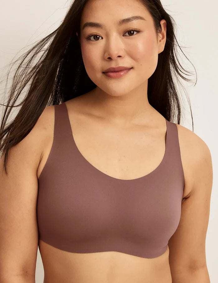 | Front view of model wearing the Revolution Adjustable Pullover Bra, highlighting the neckline, strap design, and  silhouette | Sola