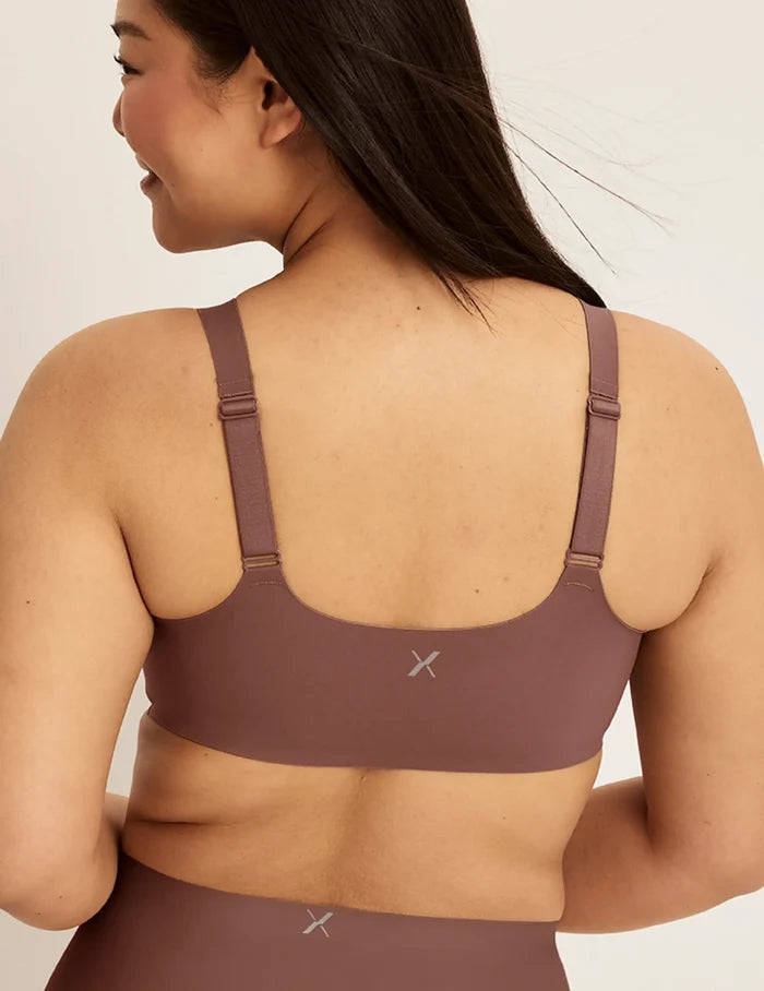 | Back view of model wearing the Revolution Adjustable Pullover Bra, highlighting the neckline, strap design, and  silhouette | Sola
