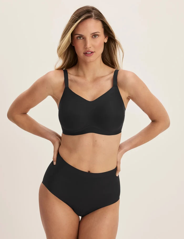 Megan is a 32E and wears a KNIX S+ | Full-body view of model wearing the Revolution Busty Bra, highlighting the neckline, strap design, and  silhouette | Black
