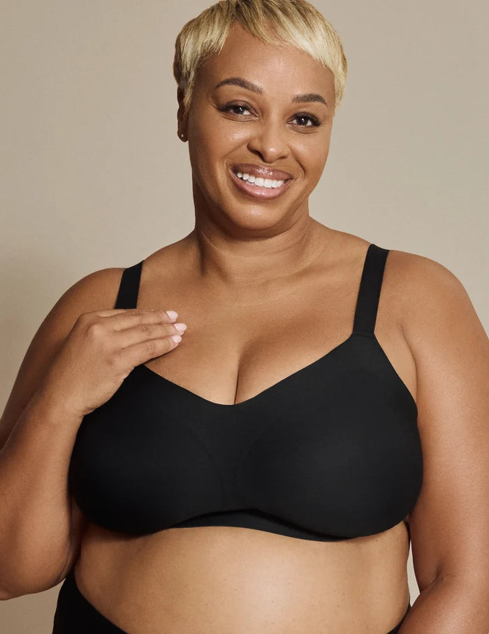 | Front view of model wearing the Revolution Busty Bra, highlighting the neckline, strap design, and  silhouette | Black