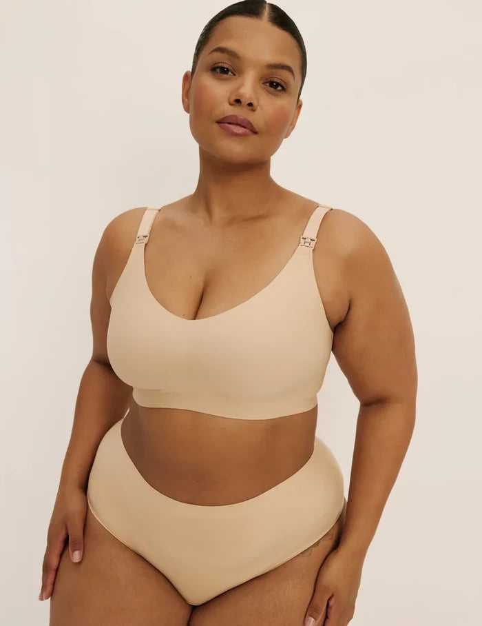 Leslie is a 38D and wearing KNIX XL+ | Front view of model wearing the Revolution Nursing Bra, highlighting the neckline, nursing clip strap design, and smooth silhouette | Warm Sand