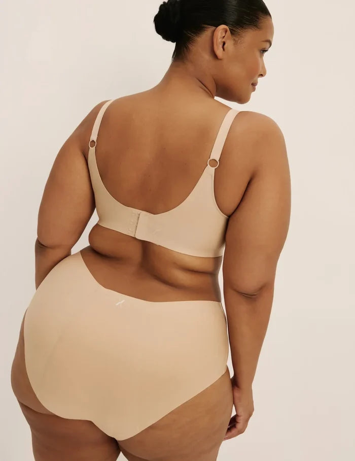 Leslie is a 38D and wearing KNIX XL+ | Back view of model wearing the Revolution Nursing Bra, highlighting the neckline, nursing clip strap design, and smooth silhouette | Warm Sand