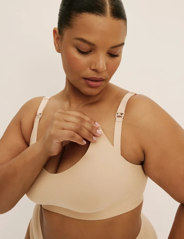 Leslie is a 38D and wearing KNIX XL+ | Front view of model wearing the Revolution Nursing Bra, highlighting the neckline, nursing clip strap design, and smooth silhouette | Warm Sand