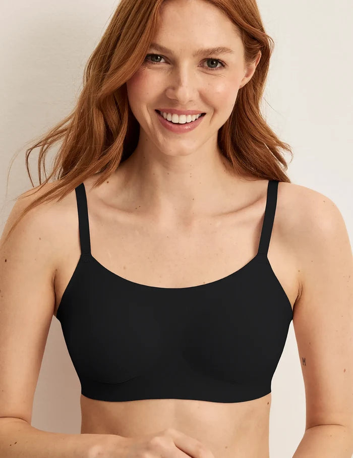 | Front view of model wearing the Revolution Scoop Bra, highlighting the neckline, strap design, and smooth silhouette | Black