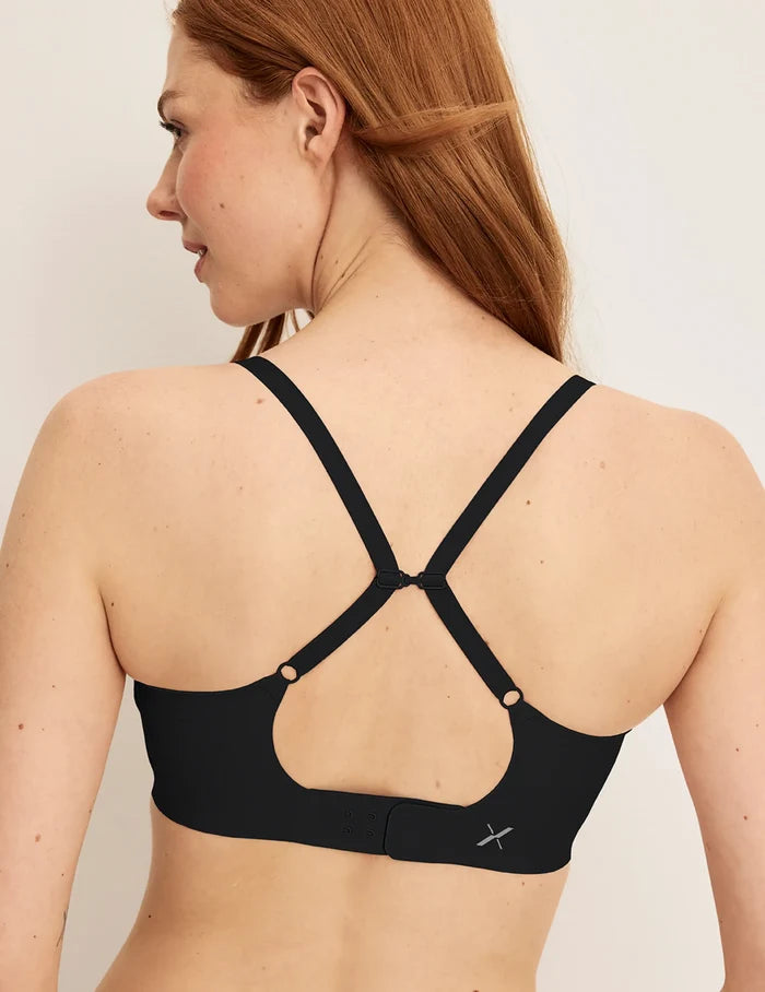 | Back view of model wearing the Revolution Scoop Bra, highlighting the neckline, strap design, and smooth silhouette | Black