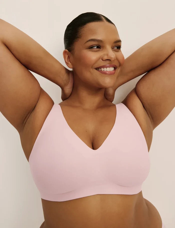 Leslie is a 38D and wearing KNIX XL+ | Front view of model wearing the Revolution V-Neck Bra, highlighting the neckline, strap design, and smooth silhouette | Rose Water