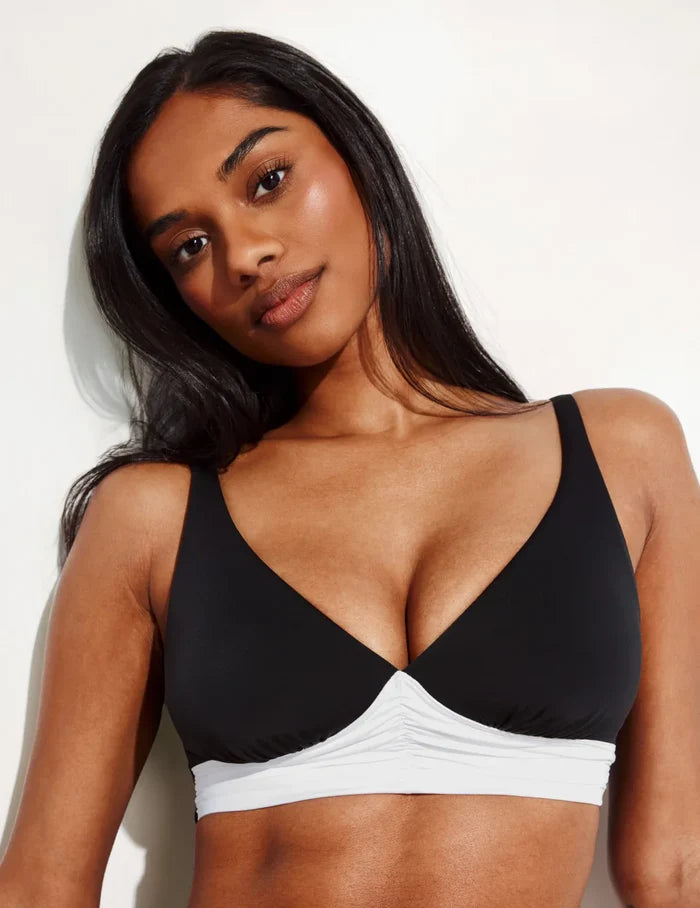Jay is a 30E wearing KNIX S+ | Front view of model wearing the Ruched Deep V Bikini Top, highlighting the neckline, strap design, and silhouette | Black/White