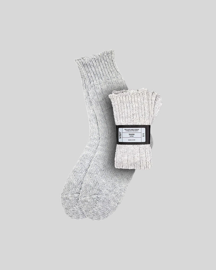 Light gray ribbed knit socks with fold-over cuff, one sock displayed flat and one rolled with branded label band.