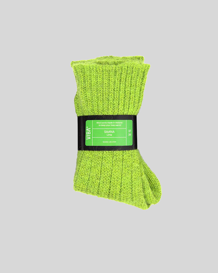 Lime green knitted wool socks with black product label band around middle.