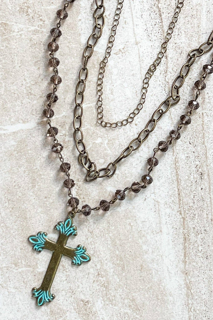 Adjustable, 3 strand necklace with 2 chain link strands and a beaded strand with cross pendant. 13"