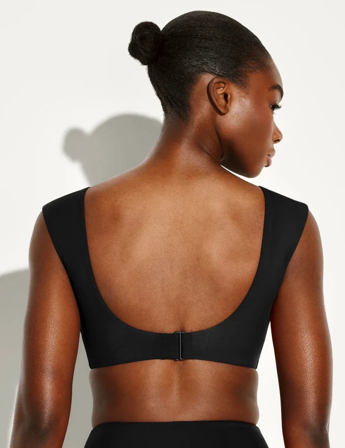 | Back view of model wearing the Sculpt Cap Sleeve Bikini Top, highlighting the neckline, strap design, and silhouette | Black