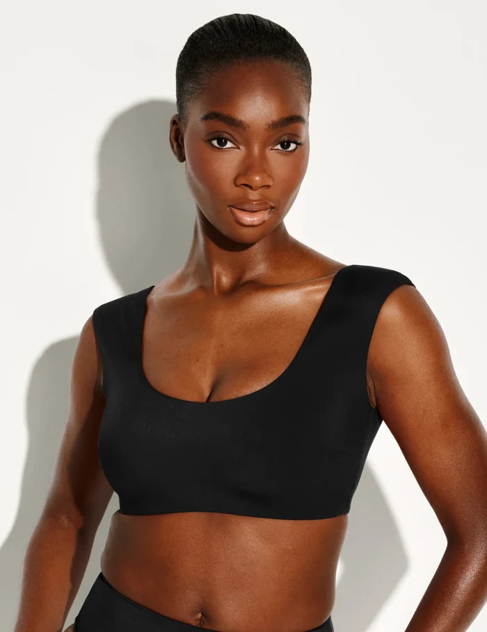 | Front view of model wearing the Sculpt Cap Sleeve Bikini Top, highlighting the neckline, strap design, and silhouette | Black