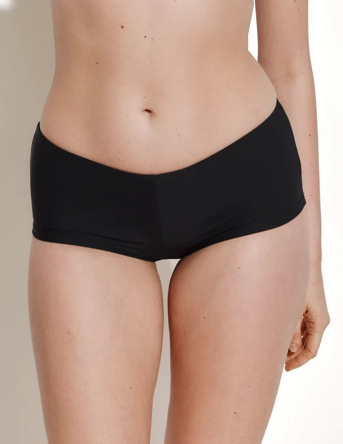 | Front view of model wearing the Sculpt Cheeky Low Rise Swim Bottom highlighting the coverage and fit | Black