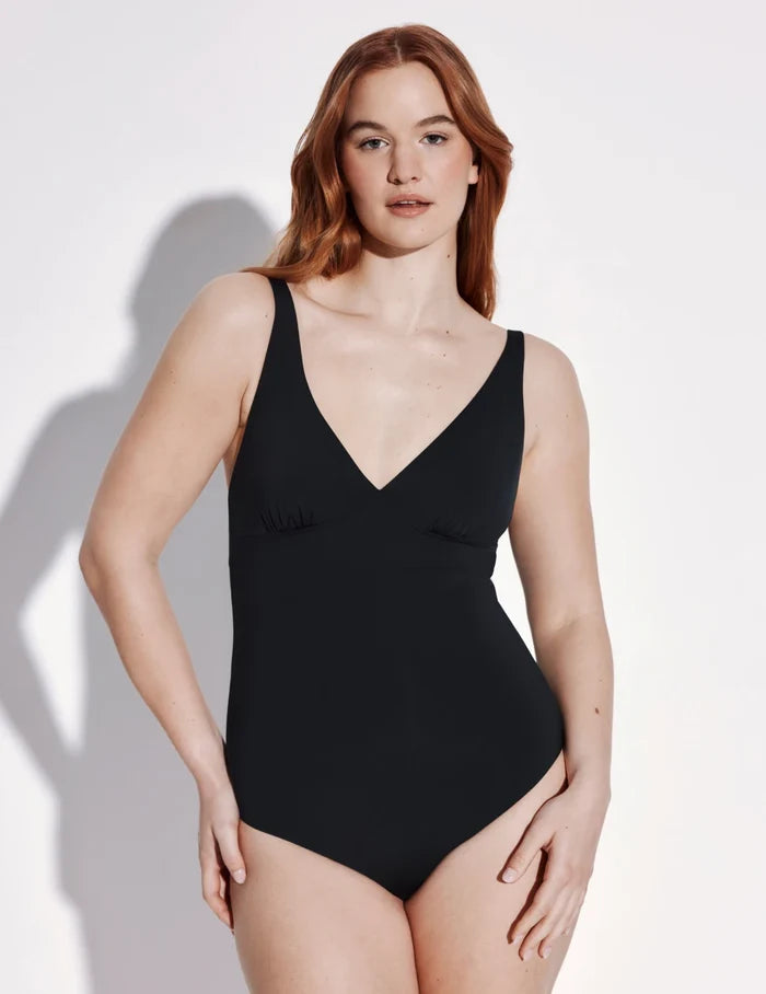 | Front view of model wearing the Sculpt Deep V One Piece Swimsuit highlighting the neckline, coverage and fit | Black