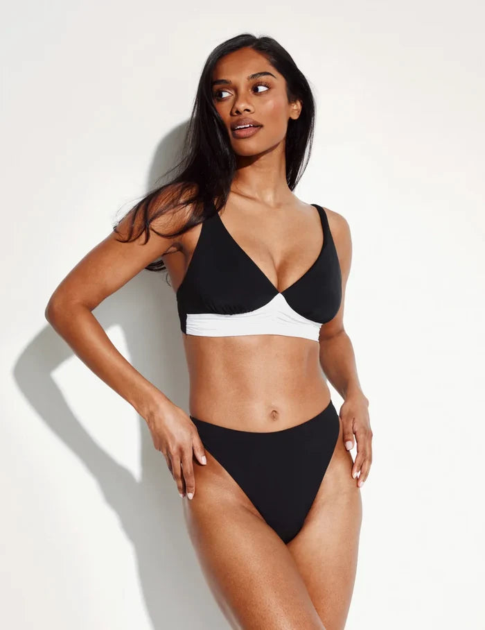 Jay is wearing KNIX S | Front view of model wearing the Sculpt High Cut Bikini Swim Bottom highlighting the coverage and fit | Black