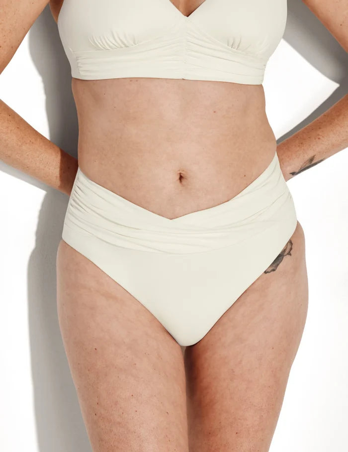 | Front view of model wearing the Sculpt Ruched Bikini Swim Bottom highlighting the coverage and fit | Ivory
