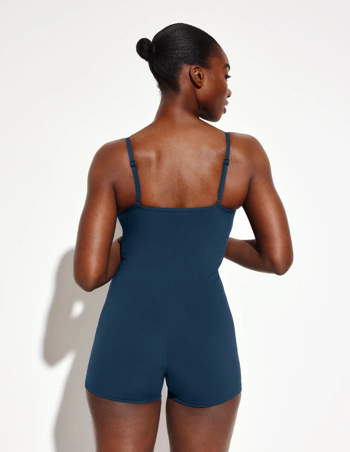 | Back view of model wearing the Sculpt Swim Shortie One Piece highlighting the coverage and fit | Horizon