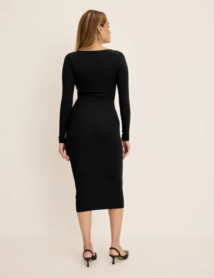 Sarah is a 34DD, 38.5" hips and wearing KNIX M | Back view of model wearing the SculptRib™ Cotton Henley Dress highlighting the neckline, fabric and hugging fit | Black