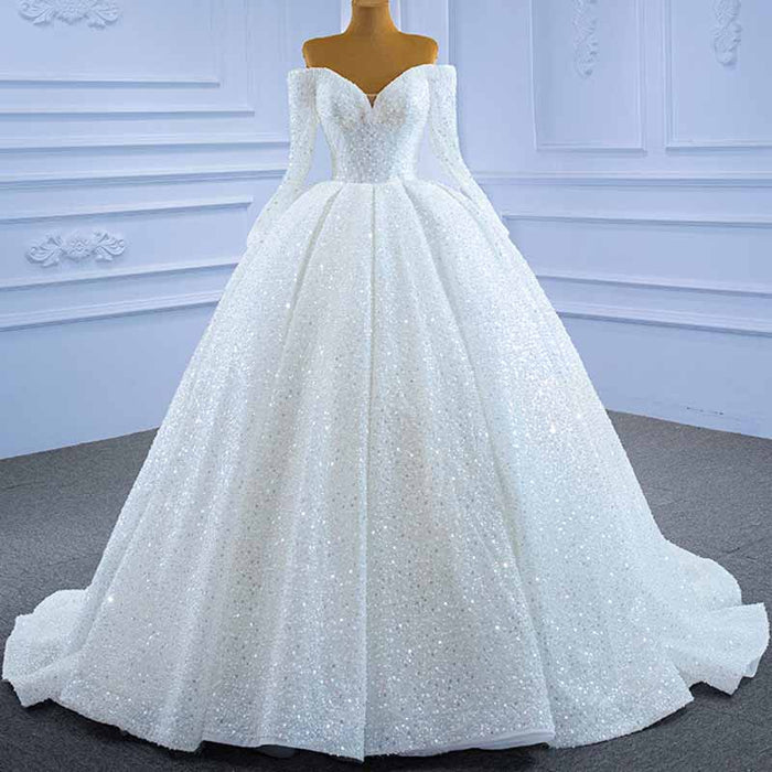 Elegant off the shoulder sequin wedding dress with a voluminous ball gown skirt and long sleeves