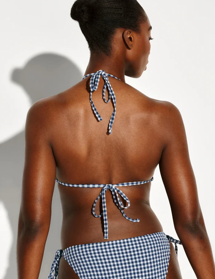 | Back view of model wearing the Seersucker Sculpt Triangle Bikini Top, highlighting the neckline, strap design, and  silhouette | Navy Seersucker