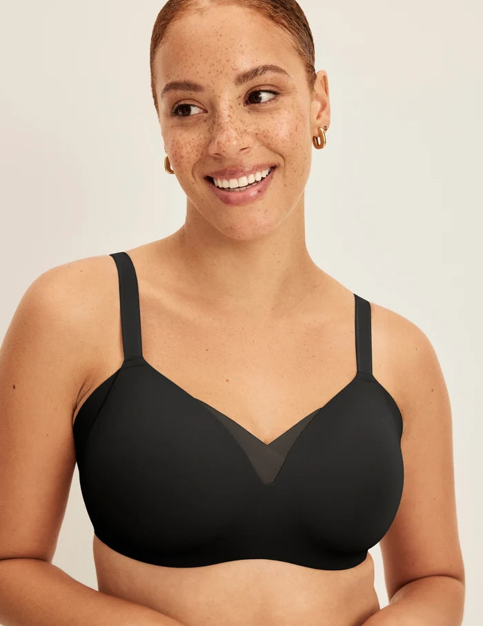 Adecia is a 34D wearing KNIX M+ | Front view of model wearing the Shape & Smooth Bra, highlighting the neckline, strap design, and smooth silhouette | Black