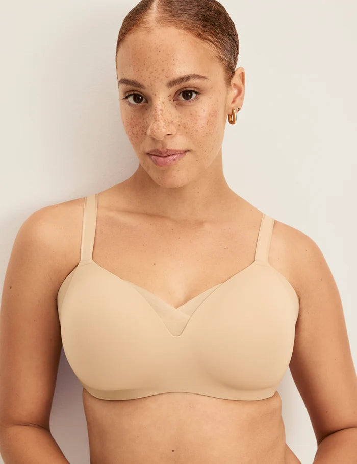 Adecia is a 34D wearing KNIX M+ | Front view of model wearing the Shape & Smooth Bra, highlighting the neckline, strap design, and smooth silhouette | Warm Sand