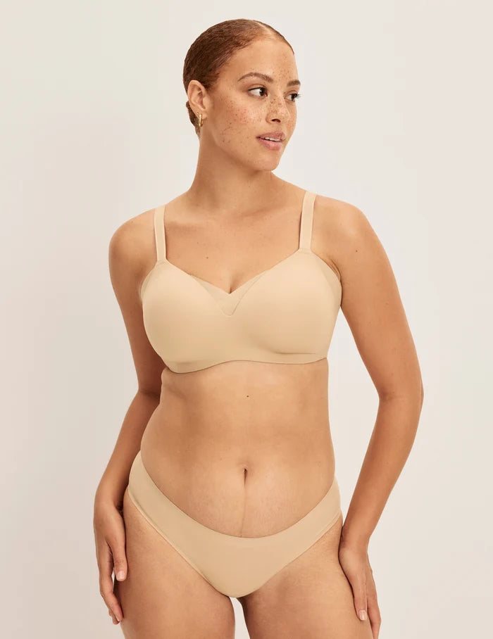 Adecia is a 34D wearing KNIX M+ | Full-body view of model wearing the Shape & Smooth Bra, highlighting the neckline, strap design, and smooth silhouette | Warm Sand