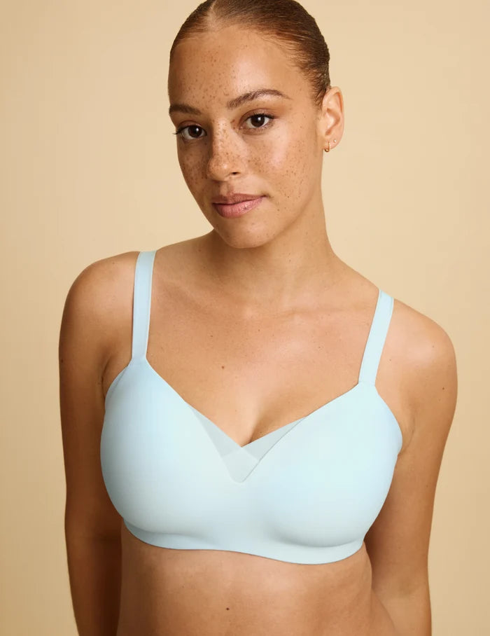 Adecia is a 34D wearing KNIX M+ | Front view of model wearing the Shape & Smooth Bra, highlighting the neckline, strap design, and smooth silhouette | Blue Light
