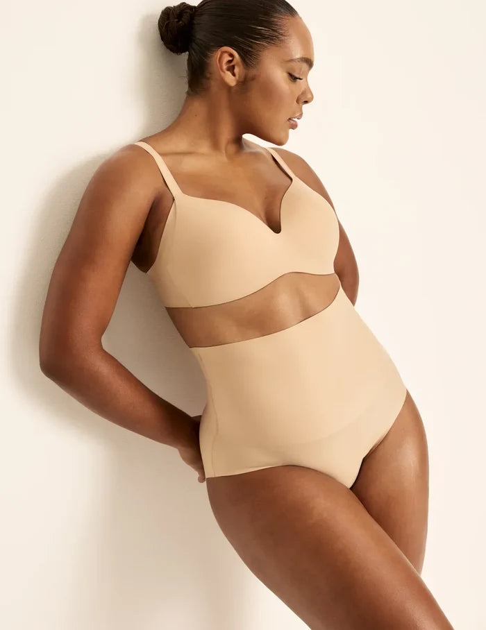 Amber has 46” hips, is 5’10.5” tall and wears a size L | Front view of model wearing the Shaper High Rise Leakproof Briefs, highlighting the coverage and smooth fit | Warm Sand