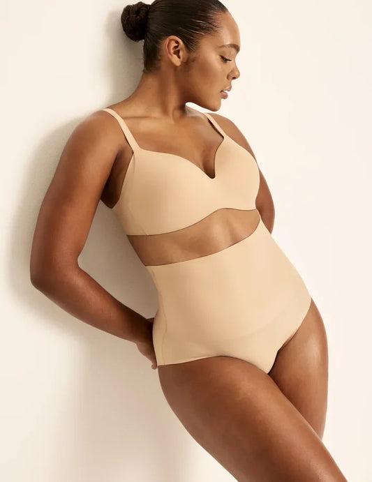 Amber has 46” hips, is 5’10.5” tall and wears a size L | Front view of model wearing the Shaper High Rise Leakproof Briefs, highlighting the coverage and smooth fit | Warm Sand