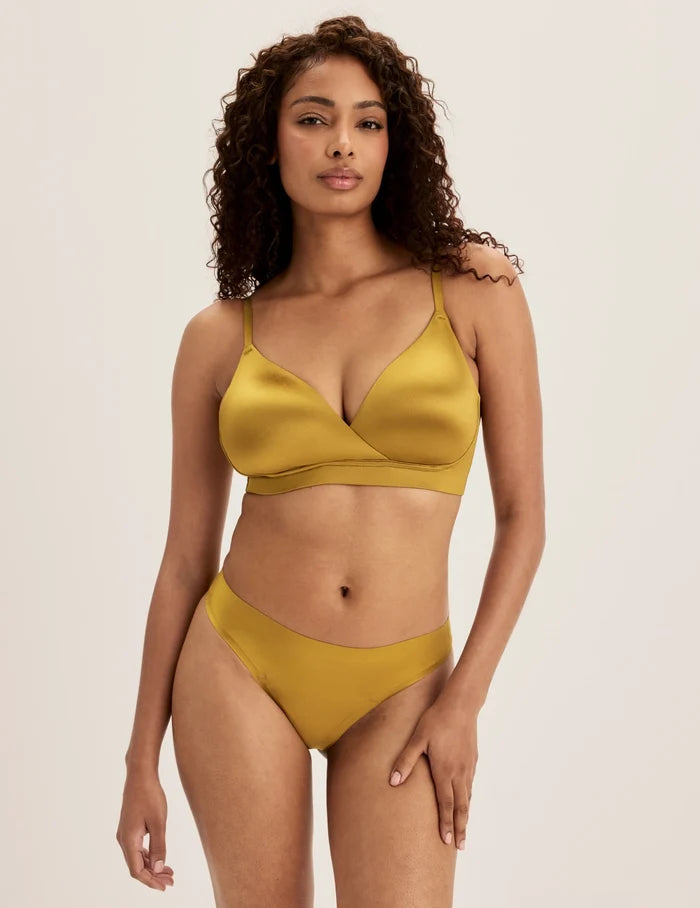 | Full-body view of model wearing the Shimmer Stretch Bra, highlighting the neckline, design, and silhouette | Burnished Gold