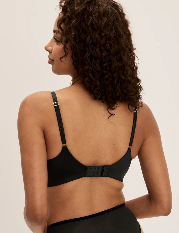 | Back view of model wearing the Shimmer Stretch Bra, highlighting the neckline, design, and silhouette | Black