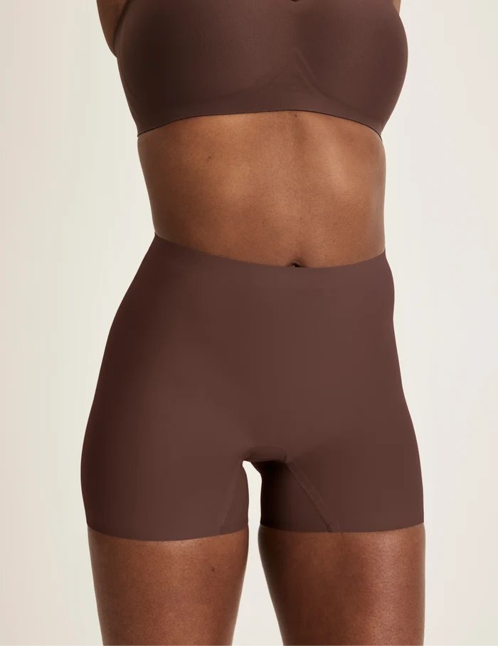 Orlane is wearing KNIX S | Front view of model wearing the Shortie Thigh Saver® 4”, highlighting the coverage and smooth fit | Sable