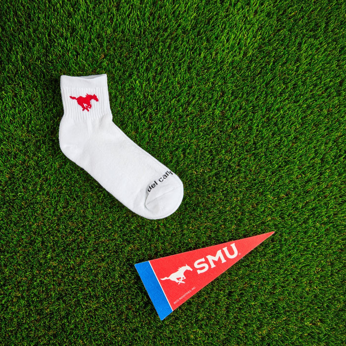 Flat lay of Del Campo SMU Mustangs golf socks with game-day props