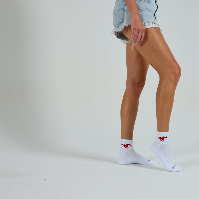 Woman wearing Del Campo SMU Mustangs golf socks, studio shot, no shoes