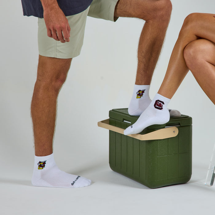 Two models wearing Del Campo South Carolina Pack golf socks in studio