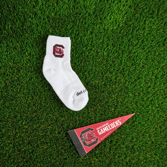 Flat lay of Del Campo South Carolina Gamecocks golf socks with game-day props