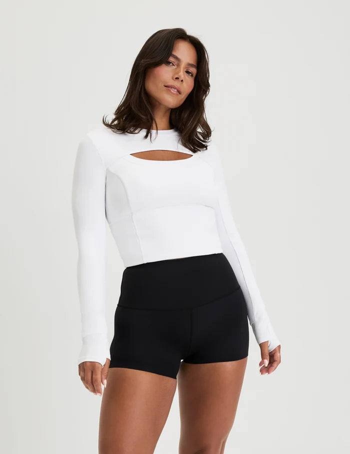 | Front view of model wearing the Studio Cutout Bra Top, highlighting the keyhole neckline, flattering design, and silhouette | White
