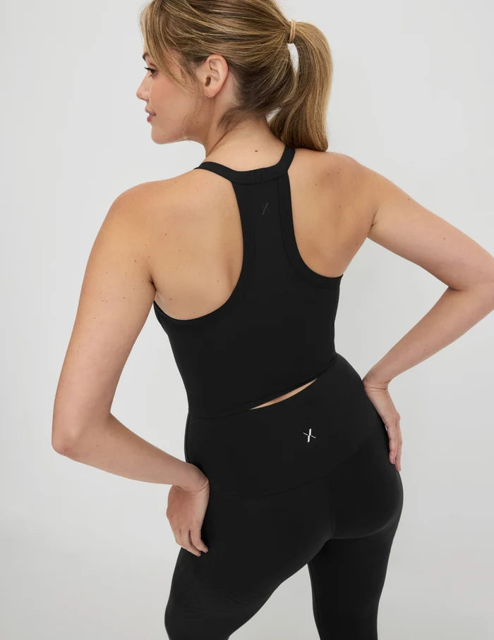 | Back view of model wearing the Studio Ribbed Bra Top, highlighting the neckline, design, and silhouette | Black