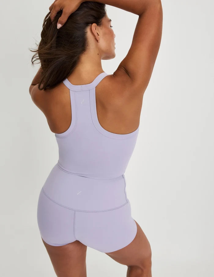 | Back view of model wearing the Studio Ribbed Bra Top, highlighting the neckline, design, and silhouette | Purple Heather