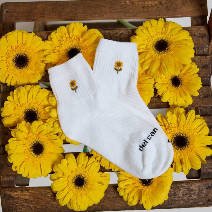 Del Campo Flower Pack golf socks featuring four floral designs: rose, sunflower, violet, and pink tulip