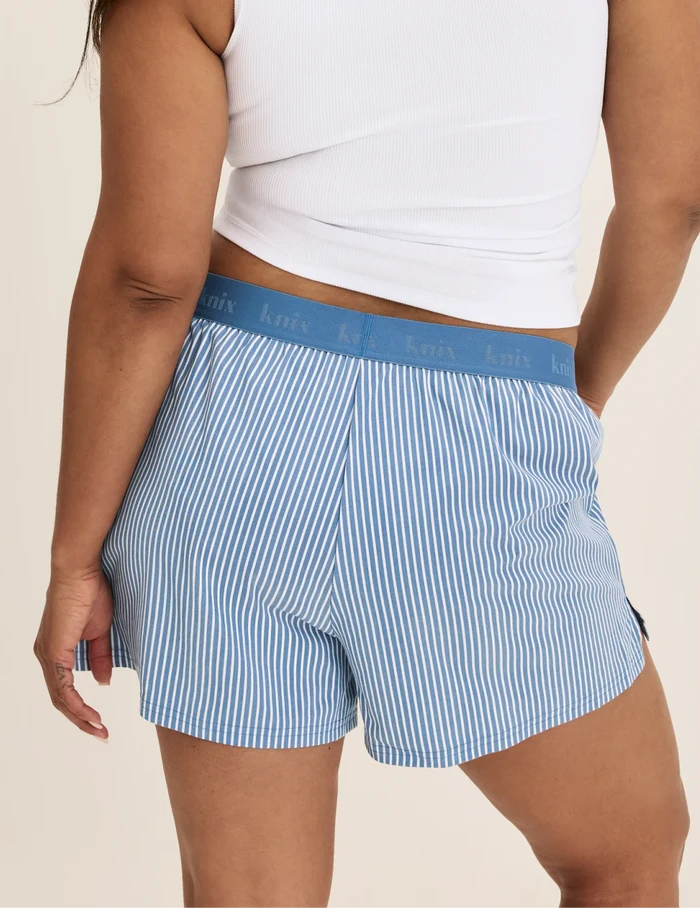 Binta has 44” hips and wears KNIX L | Back view of model wearing the Super Leakproof® Dream Boxer™ highlighting the coverage and fit | Blue Stripe
