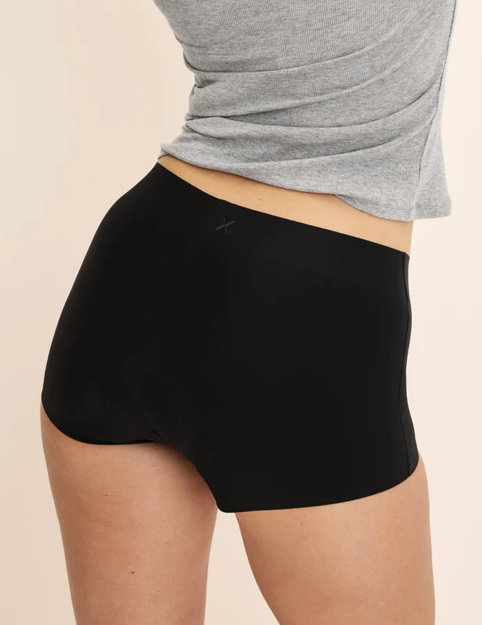 Sarah has 38.5” hips and wears KNIX M | Back view of model wearing the Super Leakproof® Dream Short™ highlighting the coverage and smooth fit | Black