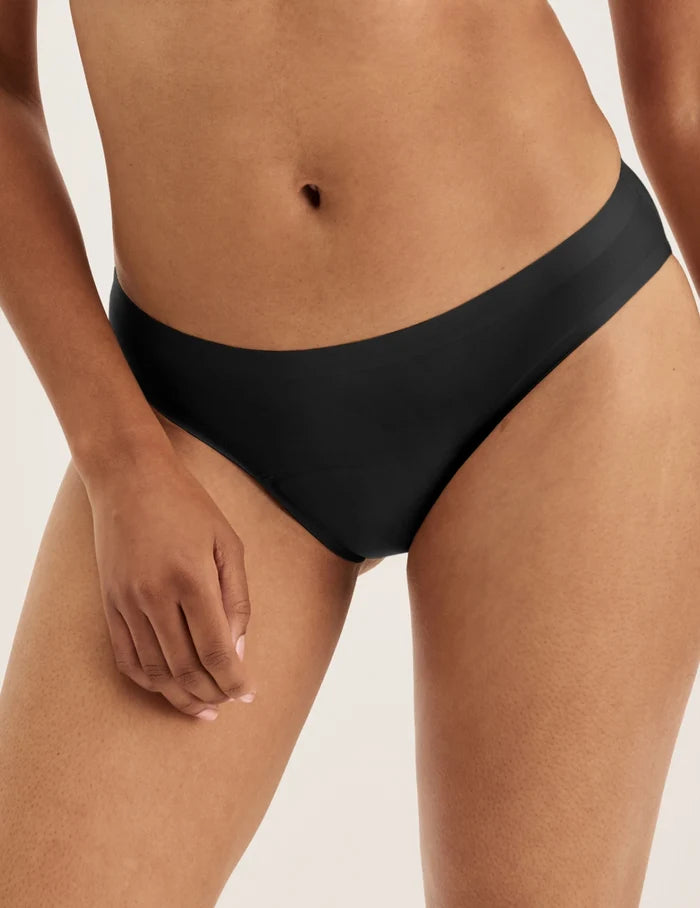 Ashley has 39” hips and wears KNIX S | Front view of model wearing the Super Leakproof® No-Show Bikini highlighting the coverage and smooth fit | Black