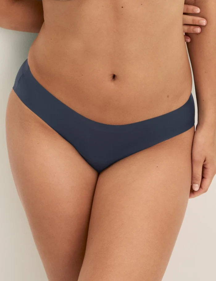 Megan has 36.5” hips and wears KNIX S | Front view of model wearing the Super Leakproof® No-Show Bikini highlighting the coverage and smooth fit | Twilight Navy