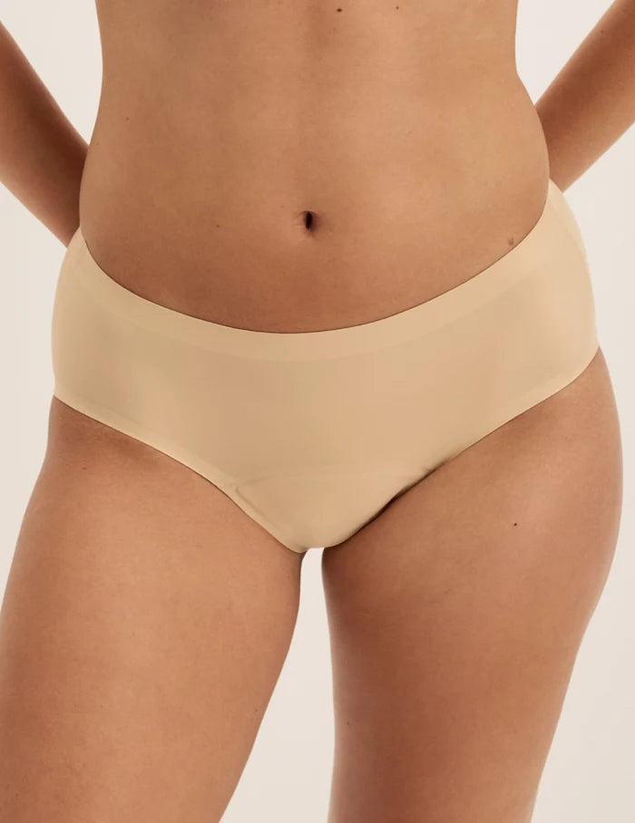 Megan has 36.5” hips and wears KNIX S | Front view of model wearing the Super Leakproof® No-Show Boyshort highlighting the coverage and smooth fit | Warm Sand